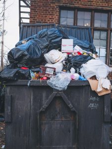 City dumpster piled high
